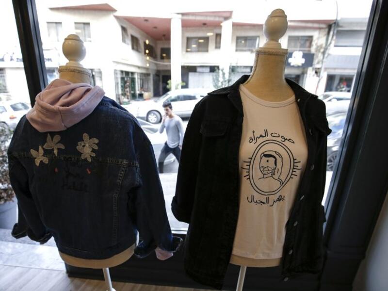 This picture shows clothing from the Palestinian feminist fashion label "BabyFist" on display at a shop in Ramallah in the occupied West Bank. 
ABBAS MOMANI / AFP