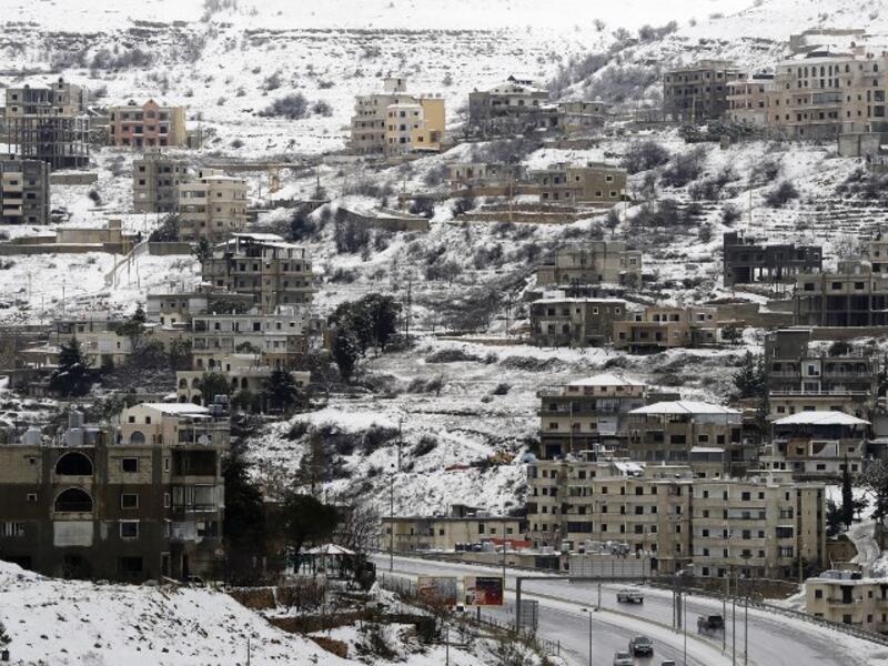 Village of Sofar, some 30 kilometres (20 miles) east of the Lebanese capital Beirut on January 7, 2019, shows a neighbouring village covered in snow as a fierce winter storm lashed the east coast of the Mediterranean. 
JOSEPH EID / AFP
