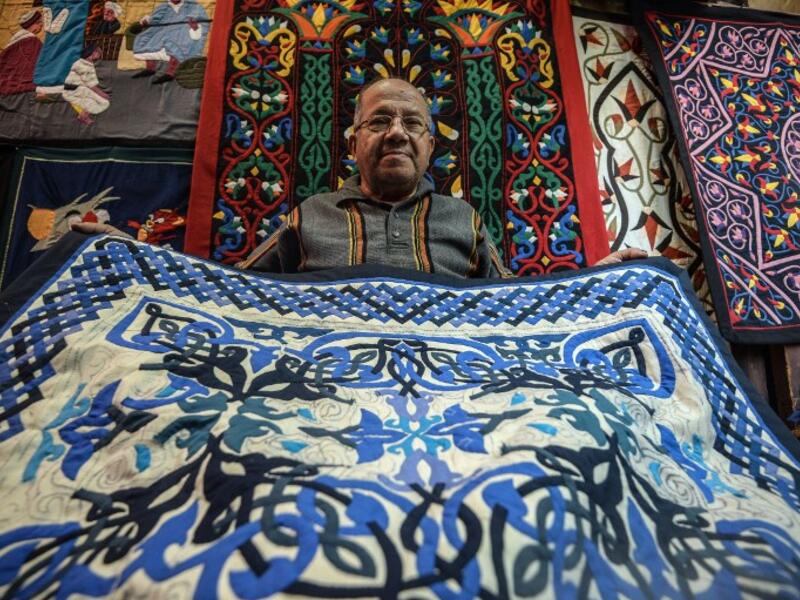 An Egyptian craftsman showcases a tapestry in his shop in Khayamiya Street, or the Street of Tent-makers, in the old city of the Egyptian capital Cairo. Mohamed el-Shahed / AFP