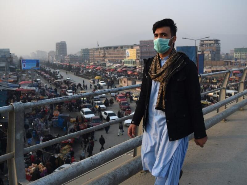 In this photograph an Afghan resident wearing a face mask walks along an overpass amid heavy smog conditions in Afghanistan's capital Kabul. 
WAKIL KOHSAR / AFP