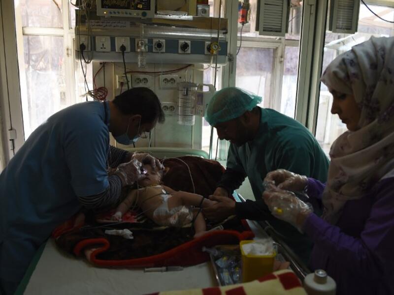 In this photograph an Afghan child suffering from respiratory problems is treated by medical staff at the Indira Gandhi Children's Hospital in Kabul. 
WAKIL KOHSAR / AFP