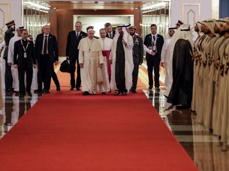 Pope Francis (C-L) is welcomed by Abu Dhabi's Crown Prince Sheikh Mohammed bin Zayed al-Nahyan (C-R) upon his arrival at Abu Dhabi International Airport in the UAE capital on February 3, 2019. 
Andrew Medichini / POOL / AFP