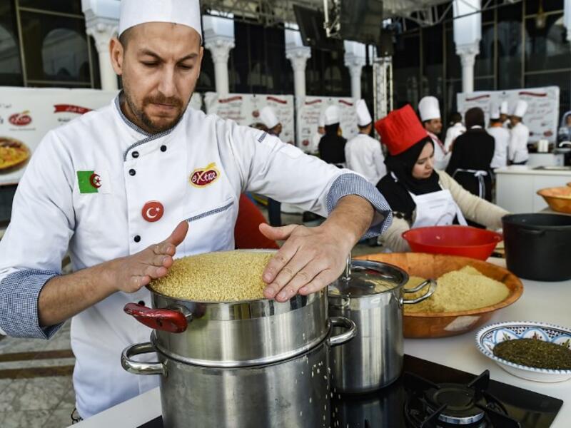 An Algerian chef prepares couscous during the 2nd edition of the International Couscous Festival at the Moufdi Zakaria Palace of Culture in  Algeria
RYAD KRAMDI / AFP