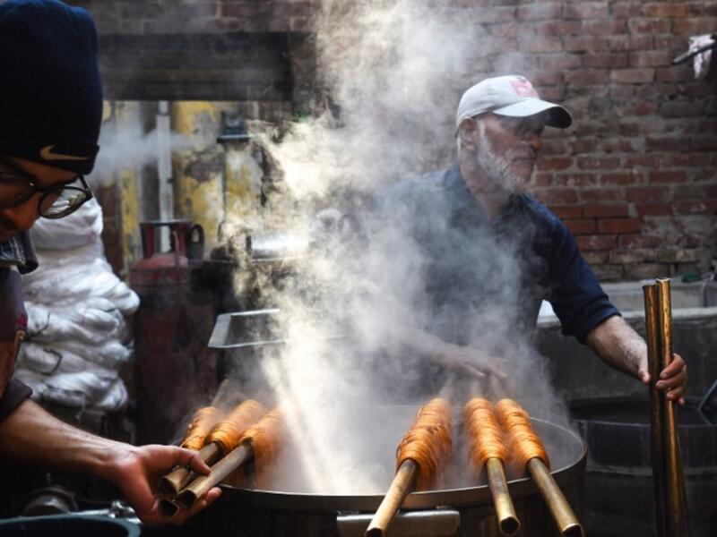 Pakistani workers dye fabric threads at a factory in Lahore 
ARIF ALI / AFP