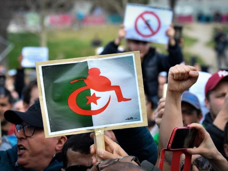 Protesters hold placards during a sit-in against the Algerian presidential bid for a fifth term in office
GERARD JULIEN / AFP