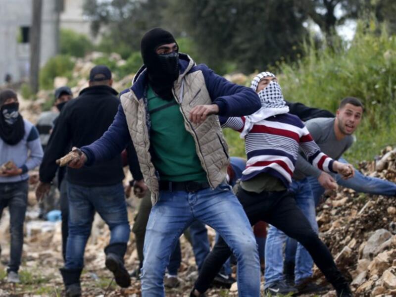 Palestinian protesters throw stones towards Israeli forces during clashes following a weekly demonstration against the expropriation of Palestinian land by Israel in the village of Kfar Qaddum, near Nablus 
JAAFAR ASHTIYEH / AFP
