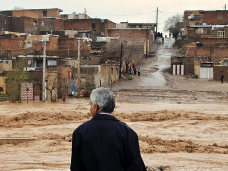 An Iranian man looking at the flooded street in a village around the city of Ahvaz, in Iran's Khuzestan province (Twitter)