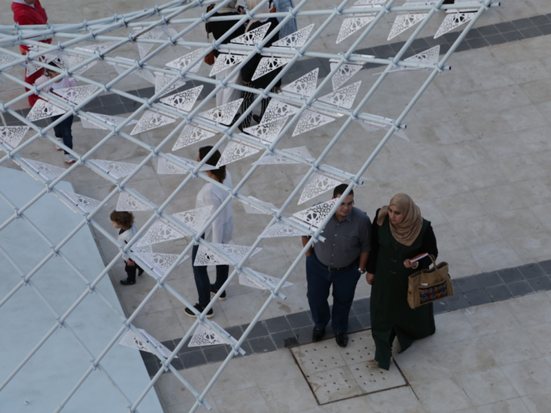 Attendees at Amman Design Week walk under a swarm of mechanical butterflies in a project called ‘A Path of Synergy,’ created by architects and visual artists Rawan Kakish and Hamad al Sultan. (Al Bawaba/Salim Essaid)