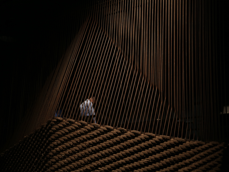 A man appears through a lattice of woven rope and bending rebar, exploring movement through the historical site of Jordan’s Wadi Rum. A project designed by Anmahian Winton Architects Alex Anmahian, Mazen Sakr, and Aaron Bruckerhoff. (Al Bawaba/Salim Essaid) 