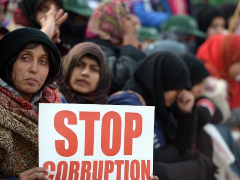 Pakistani supporters of Canadian-Pakistani cleric Tahir-ul Qadri hold placards during a protest march in Islamabad on Tuesday. Police fired tear gas on protesters in Islamabad as clashes erupted. (AFP PHOTO/ Farooq NAEEM)