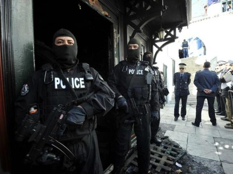 Tunisian special forces stand guard outside a mausoleum ravaged by fire in what is thought to have been an arson attack on Sunday in Sidi Bou Said. (AFP PHOTO /FETHI BELAID)