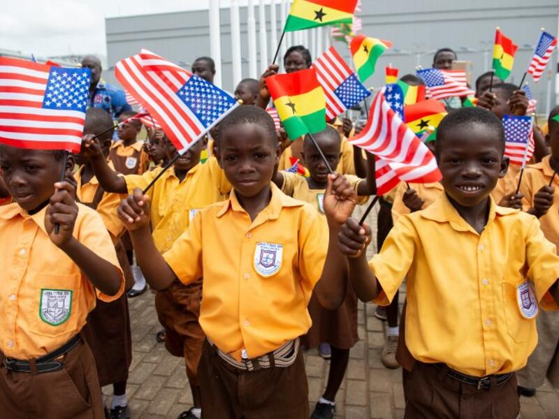 Children wave the American and Ghana flags for US First Lady Melania Trump during an arrival ceremony after landing at Kotoka International Airport in Accra October 2, 2018 as she begins her week long trip to Africa to promote her 'Be Best' campaign. (SAUL LOEB / AFP)

