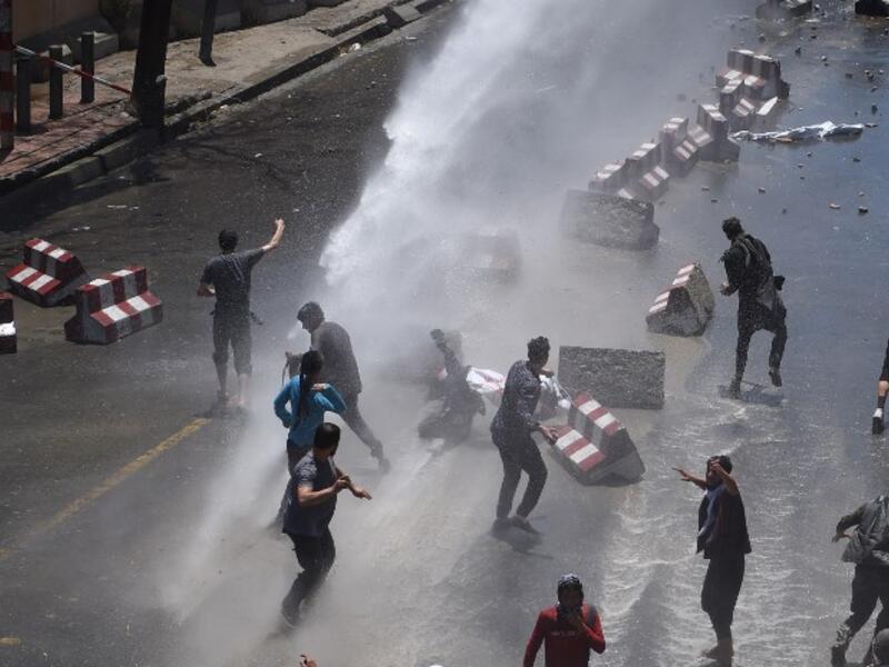 Afghan security forces use water canons to disperse protesters during clashes at a protest against the government following a catastrophic truck bomb attack near Zanbaq Square in Kabul on June 2, 2017. (Wakil Kohsar/AFP)