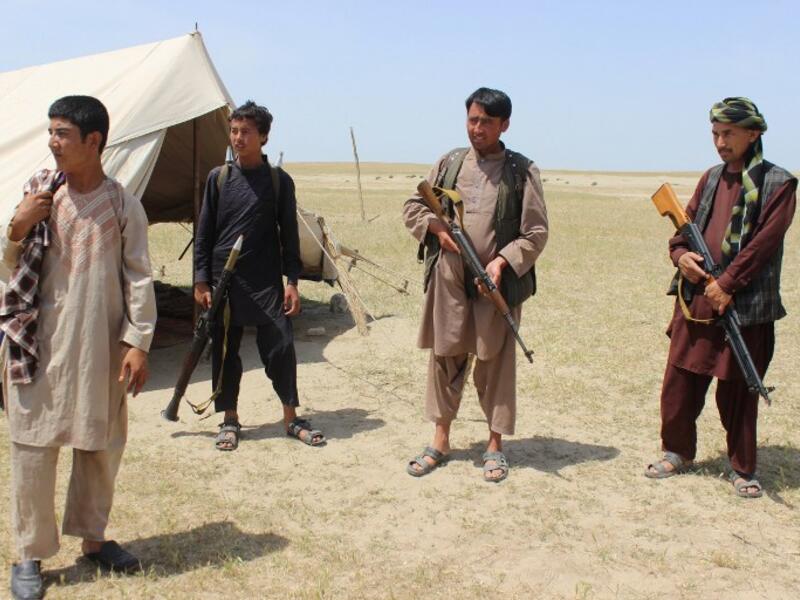 Members of an Afghan militia look on during fighting between Taliban militants and Afghan security forces near the Qala-e-Zal district in Kunduz province on May 7, 2017. (AFP/Bashir Khan Safi)