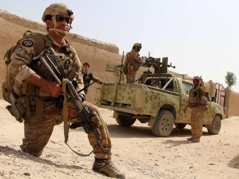 In this photograph taken on October 2, 2016, Afghan National Army commandos take position during a military operation in Helmand province. (AFP/Noor Mohammed)