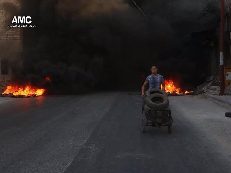 Syrian kids burning tires in Aleppo to confuse warplanes (Twitter/@ShamiRebel/Aleppo Media Center)