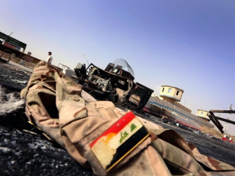 Jacket belonging to an Iraqi Army uniform lies on the ground in some 10km of east of Mosul (AFP/File)