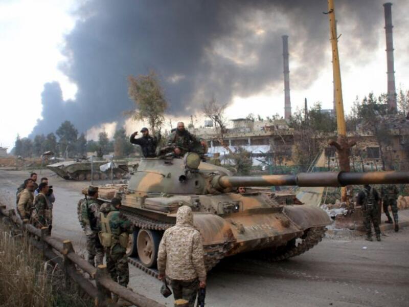 Syrian government forces patrol near Aleppo's thermal power plant after they took control of the area from Islamic State (IS) group fighters (AFP/George Ourfalian)