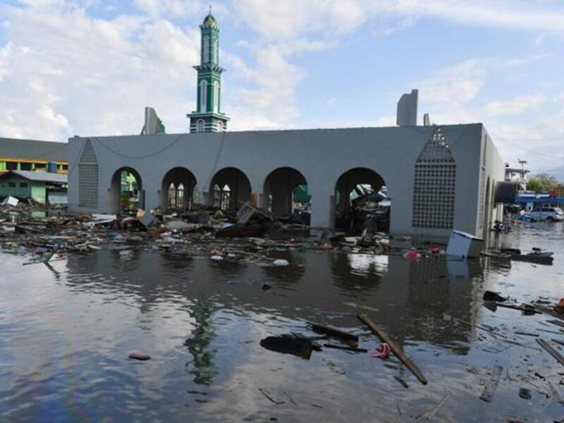 The standing remains of a mosque is seen amid waters from a tsunami surge in Palu, Indonesia's Central Sulawesi on September 30, 2018, following the September 28 earthquake and tsunami. (ADEK BERRY / AFP)