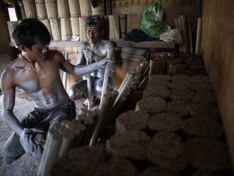 Workers covered with gunpowder material make fireworks for New Year celebrations in Bocaue, Bulacan, north of Manila on December 26, 2018. 
Noel CELIS / AFP