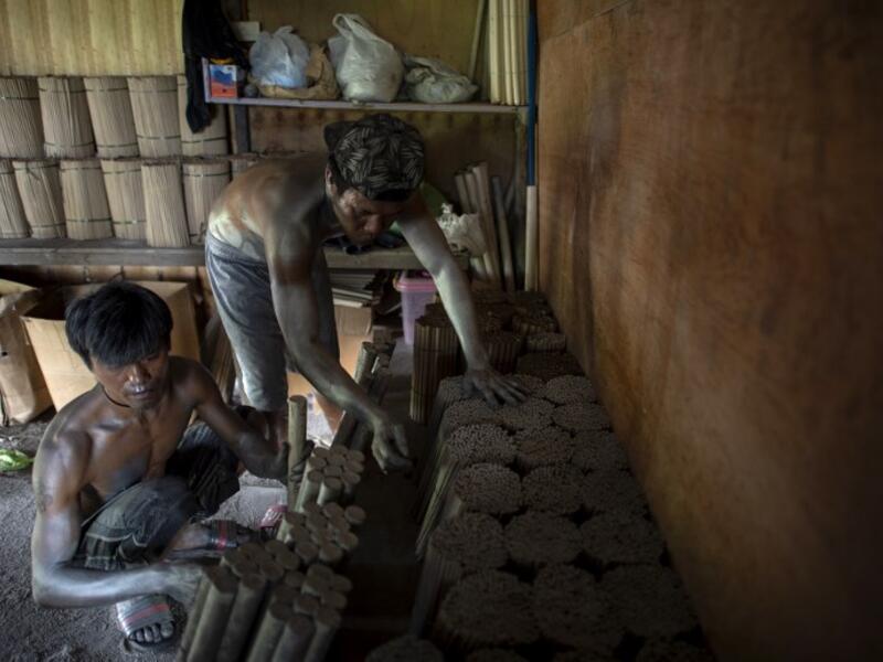 Workers covered with gunpowder material make fireworks for New Year celebrations in Bocaue, Bulacan, north of Manila on December 26, 2018. 
Noel CELIS / AFP