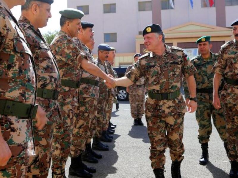 King Abdullah II shaking hands with members of the Jordanian army (AFP)