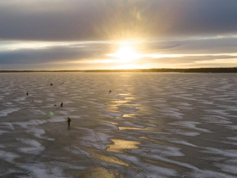 An aerial view shows men waiting near holes drilled into the frozen sea as they ice fish on the Gulf of Bothnia, near Vaasa, Western Finland on December 28, 2018, where winter daylight last for some four hours. 
Olivier MORIN / AFP