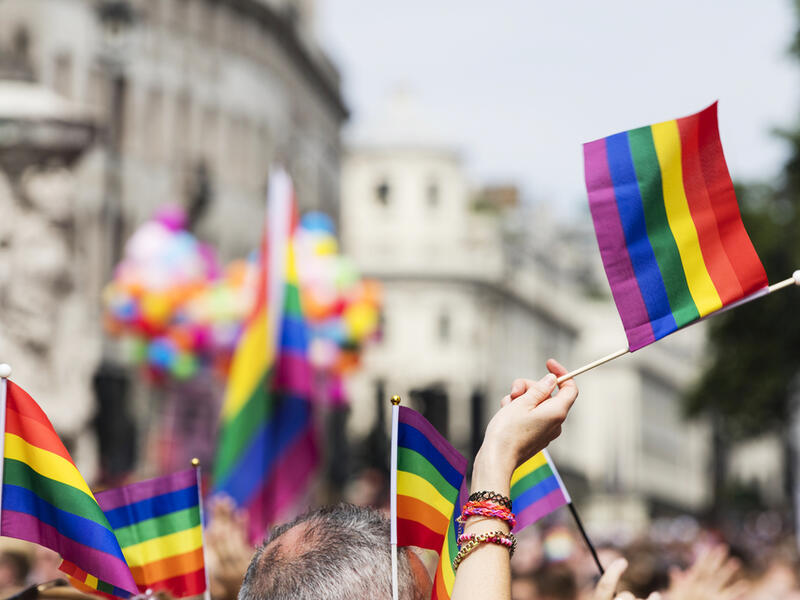 A spectator waves a gay rainbow flag at an LGBT Gay Pride march in London. (Shutterstock/ File Photo)