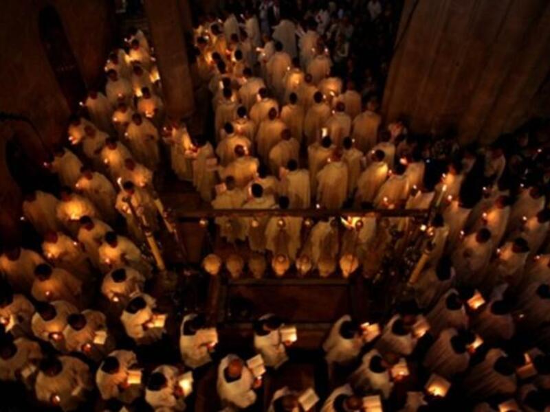 Holy tomb at Jerusalem: Greek Orthodox Patriarch Theofilos III begins the ceremony inside the Holy Sepulchre, the place where Christians believe Jesus was buried.
