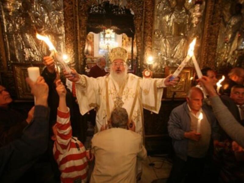 Bethlehem’s Bishop: The head of the Greek Orthodox church in Bethlehem holds the 'Holy Fire' brought from the Church of the Holy Sepulchre in Jerusalem during the 'Holy Fire' ceremony on the eve of the Orthodox Easter in Bethlehem.
