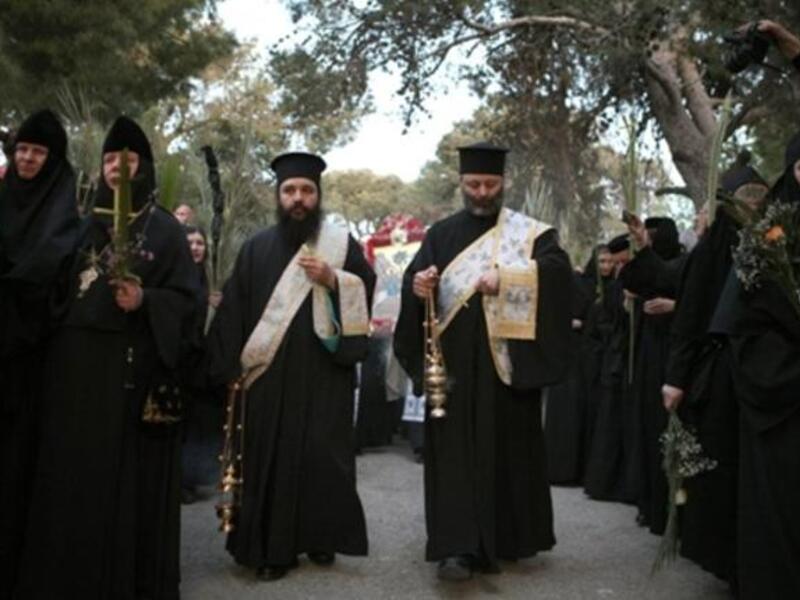 Jerusalem: Christian Orthodox priests and nuns carry palm tree branches during the Palm Sunday procession from Mt. Olives to Jerusalem's Old City.