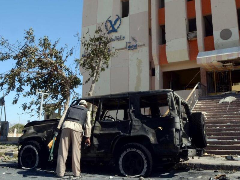 A police officer inspects the scene of a car bomb carried out earlier in Egypt's Sinai Peninsula. (AFP/File)