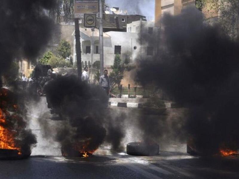 Black smoke rises from tires set on fire by demonstrators outside the Luxor town house protesting against the appointment of Adel al-Khayat (AFP)