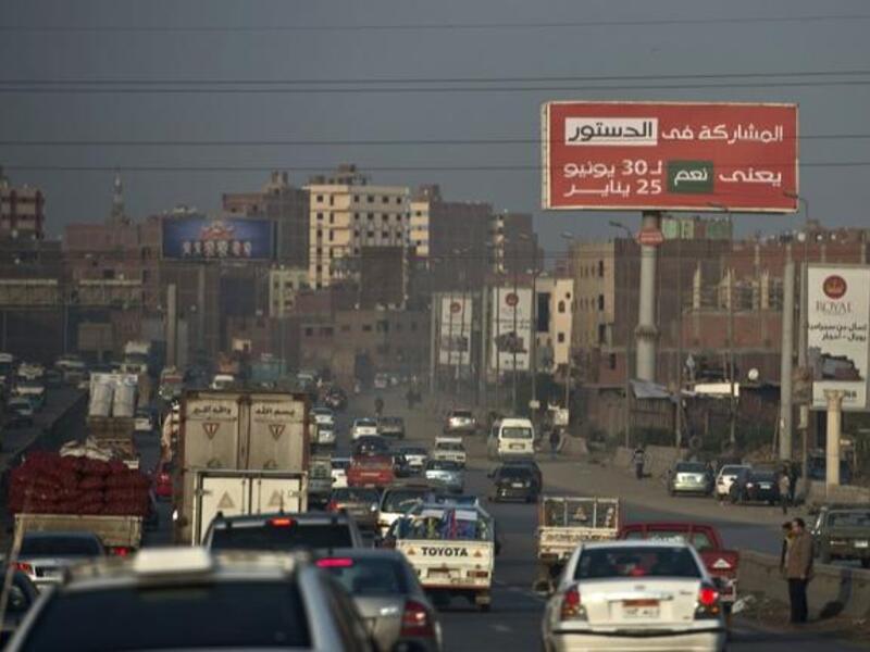 A billboard reading "participating in the constitution means YES for the 30th of June and the 25th of January" is seen on Cairo’s ring road on December 16, 2013. [AFP]