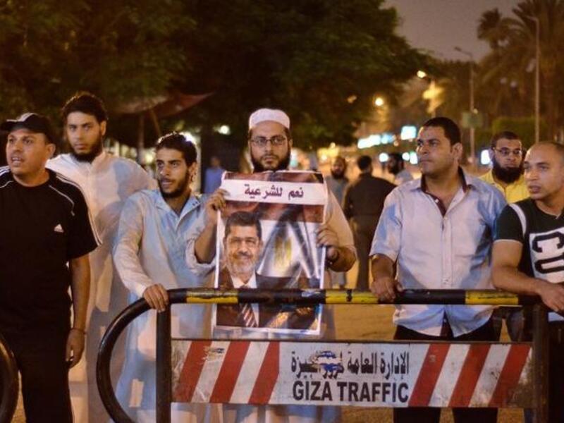 Muslim Brotherhood supporters in Cairo react to the announcement that Egyptian constitution had been suspended and Mohamed Morsi ousted as President (AFP)