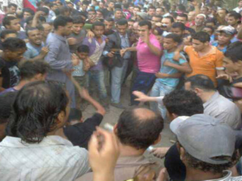 An angry mob beating in a Shiite village in Zawya Abu Muslam. Four were confirmed dead, but police did manage to save an additional 46. A closer look at the killings reveal the political strife in Egypt. (Source:Hazem Barakat)