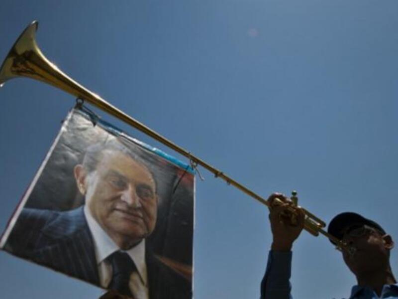 After one Mubarak fan hoisted his photo aloft a trumpet for May 11, the re-trial is once again postponed
