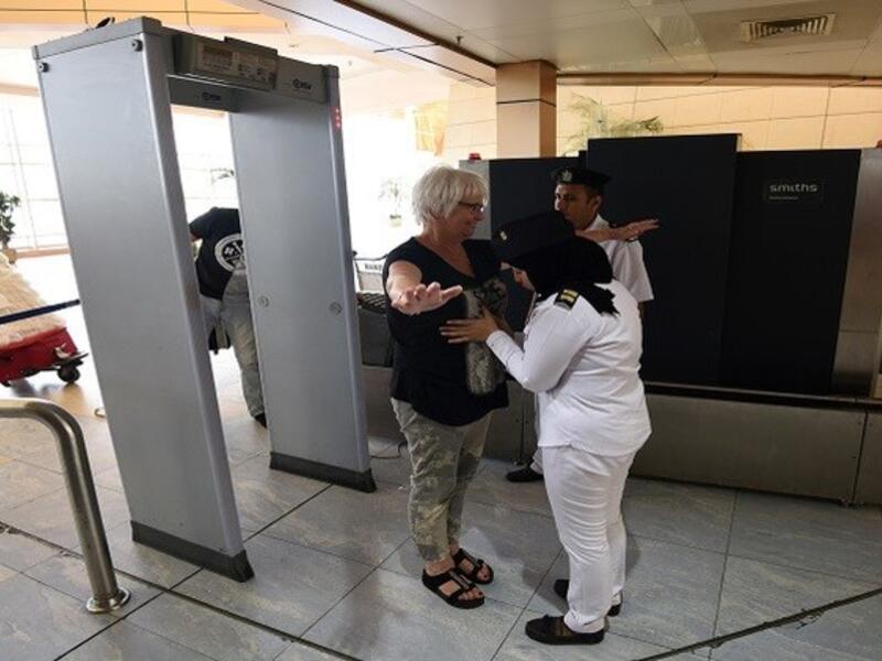 A tourist passes through the security check at Sharm El Sheikh Airport. (AFP/File)