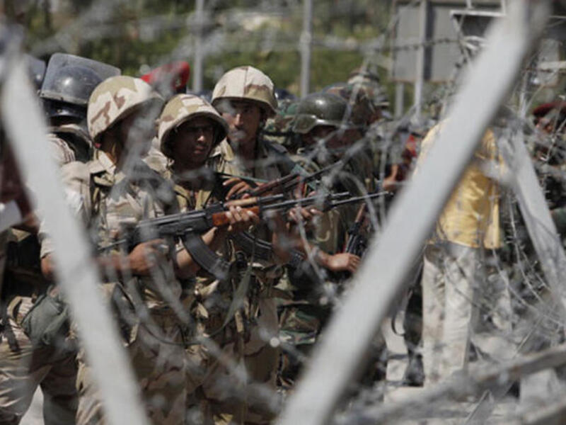  Soldiers of the Egyptian Army stand guard in front of the headquarters of the Egyptian Republican Guard in Nasr City on July 5, 2013 in Cairo, Egypt.  (Photo by Ed Giles/Getty Images).
