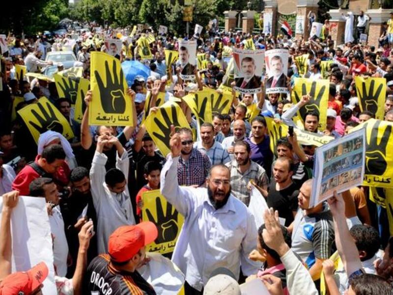 EGYPT, Cairo : Supporters of the Muslim Brotherhood and Egypt's toppled president Mohamed Morsi (portrait) take part in a demonstration in Hilwan, south of Cairo, on August 30, 2013.AFP PHOTO/STR