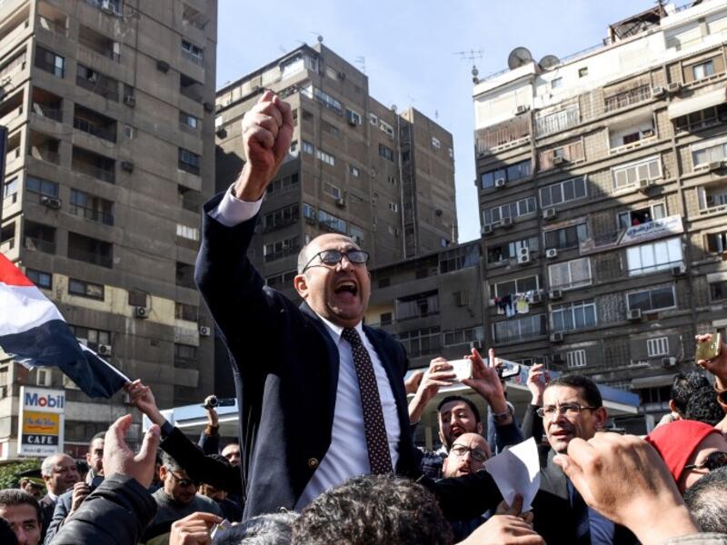 Egyptian lawyer and former presidential candidate Khaled Ali celebrates the decision amid street crowds (Mohamed El-Shahed/AFP)