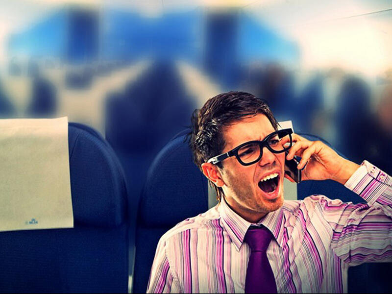 passenger on plane uses mobile