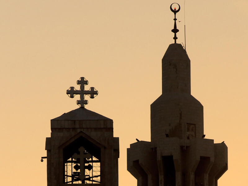 church next to mosque silhouette