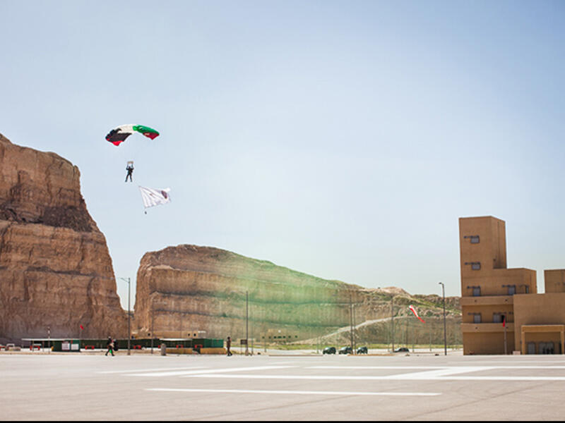 A parachuter from Jordan 71st counter-terrorism battalion prepares to land during the opening ceremonies of the seventh annual Warrior Competition at the King Abdullah II Special Operations Training Center near Amman, Jordan on April 19, 2015. This annual military competition brings together elite special operations teams from around the world.