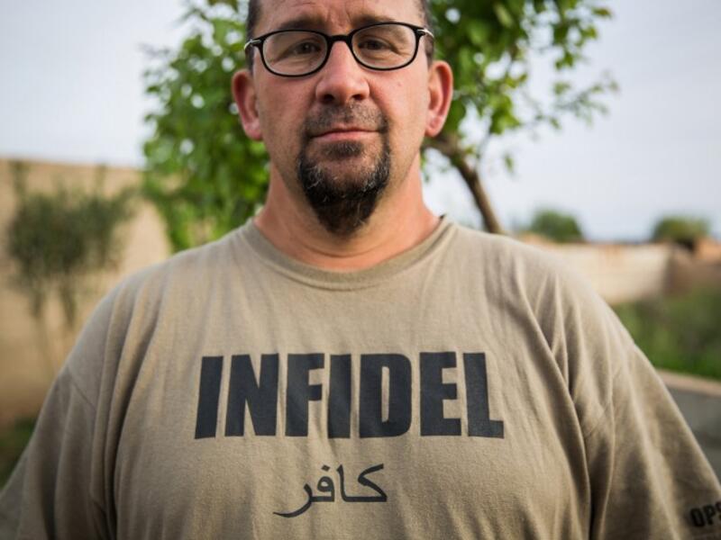 A 38-year old ex-member of the US military, nick-named ‘Hewal Cekdar,’ stands on the outskirts of Tal Tamr on April 16, 2015.