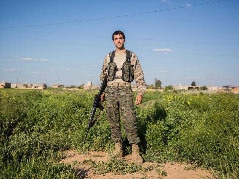 22-year old ‘Hewal Zagros’ from the US poses for a photo on April 14, 2015 on the outskirts of Tal Tamr.