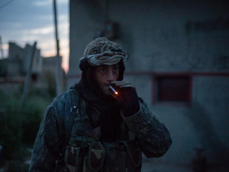 A 41-year from the US, nick-named ‘Hewal Azad,’ smokes a cigarette outside Tal Tamr on April 15, 2015.
