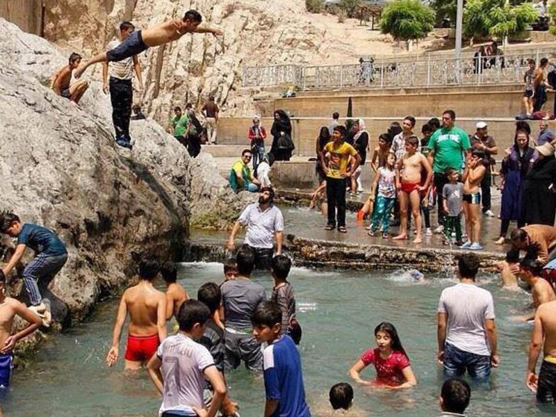 Tell your mother to put down the paper fan! Vigorous action uses lots of energy and raises body temperature. Better to burn those calories walking to the nearest cafe or mall to enjoy some time in free air conditioning.  Or do like these overheated Iranians at the Chesme-Ali recreational area near Tehran and go jump in the nearest public pool! 