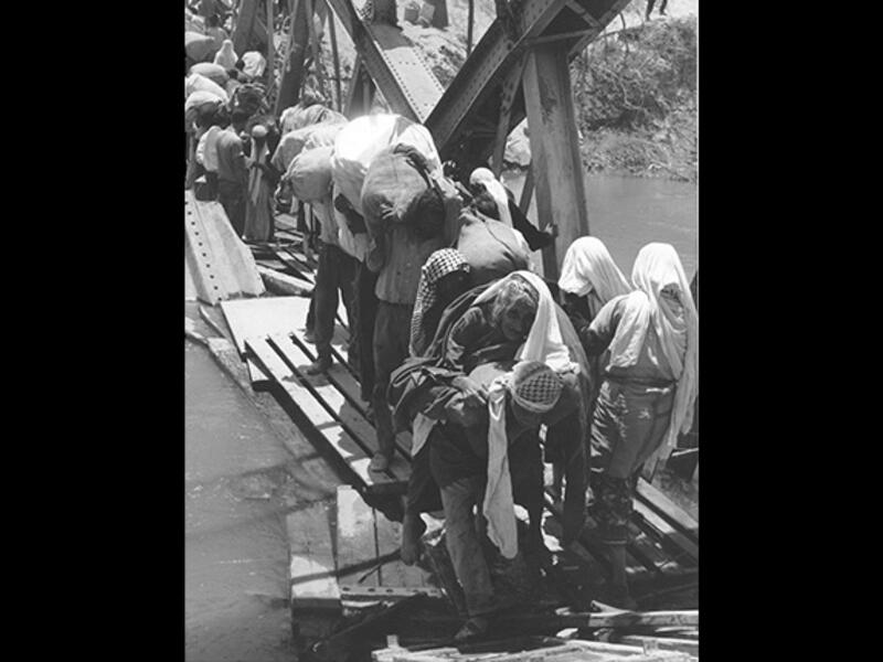 April 1948, Jordan River - Palestinians cross the Jordan River during the first Palestinian exodus known as the Nakba (catastrophe). Some 700,000 either fled or were forced out of villages during the 1948 Palestinian War, many of whom crossed into what is today Jordan. This one strikes a chord because it depicts the actual moment families left. 
