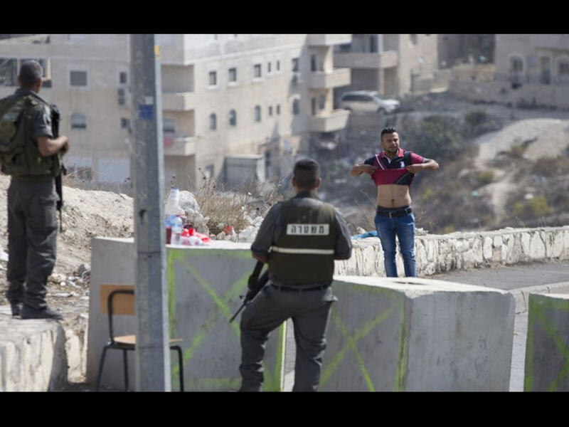 israeli checkpoint with palestinian man